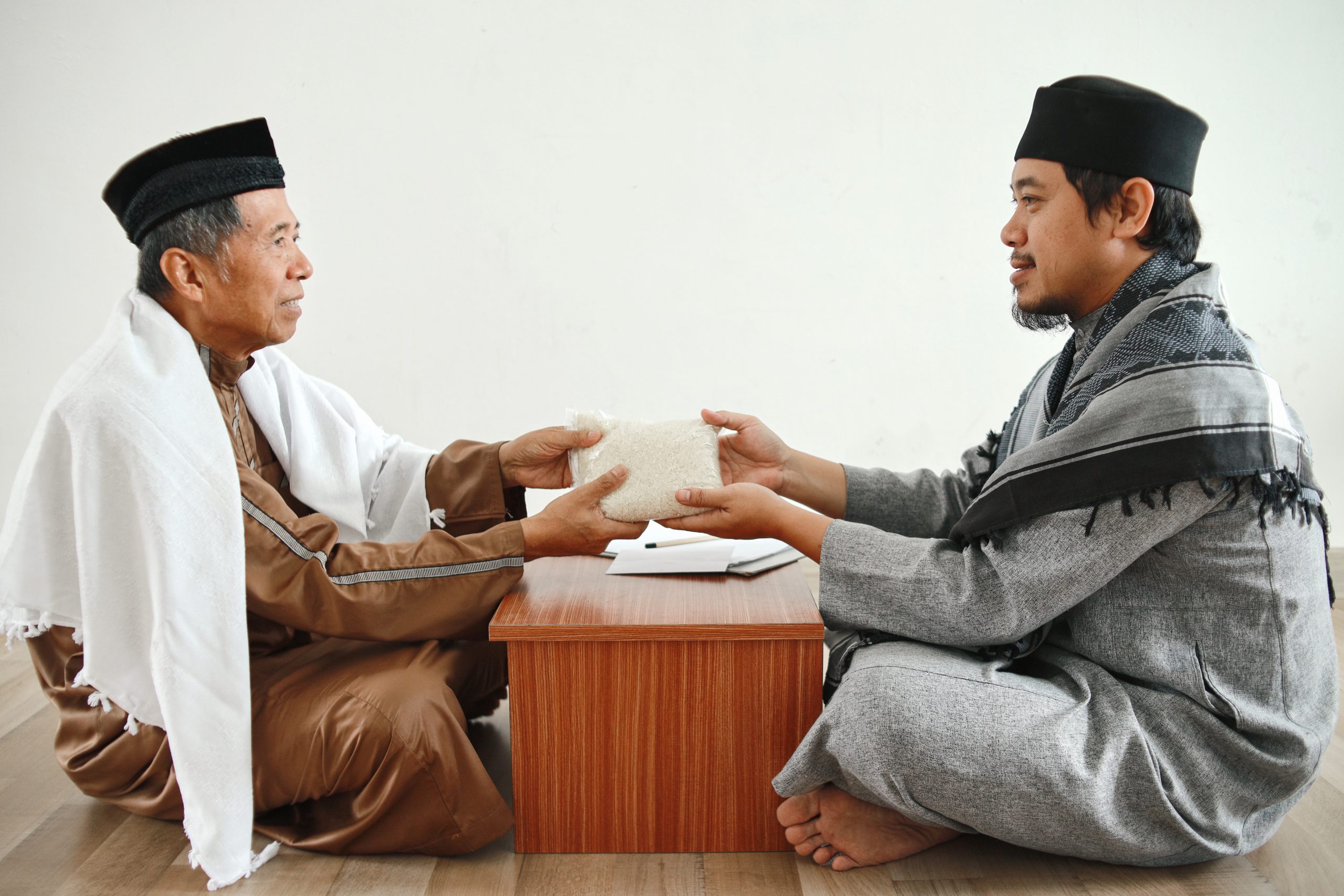 side-view-muslim-man-giving-envelope-filled-with-money-mosque-administrator-zakat-donatio